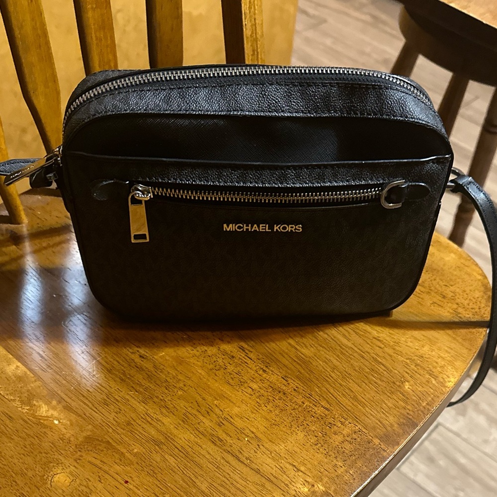 I am selling a Michael Kors bag in the color black and it is a medium size bag.